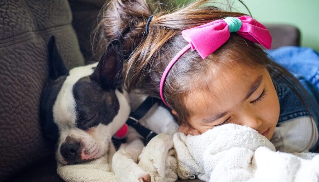 Leo Rivas / Unsplash.com girl sleeping beside a dog on the sofa
