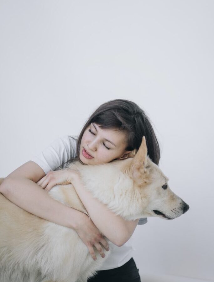 woman hugging a dog