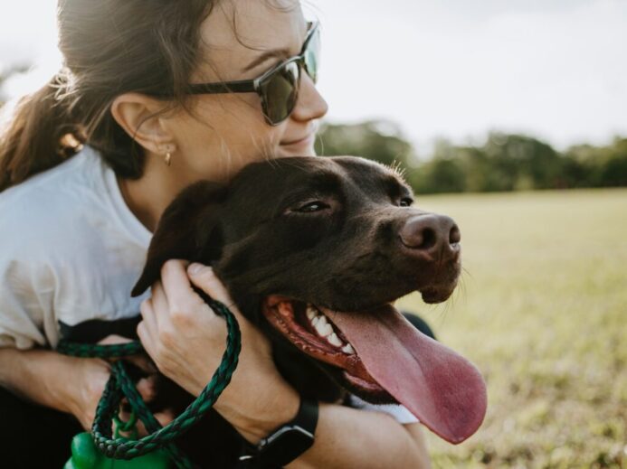 woman hugging a dog