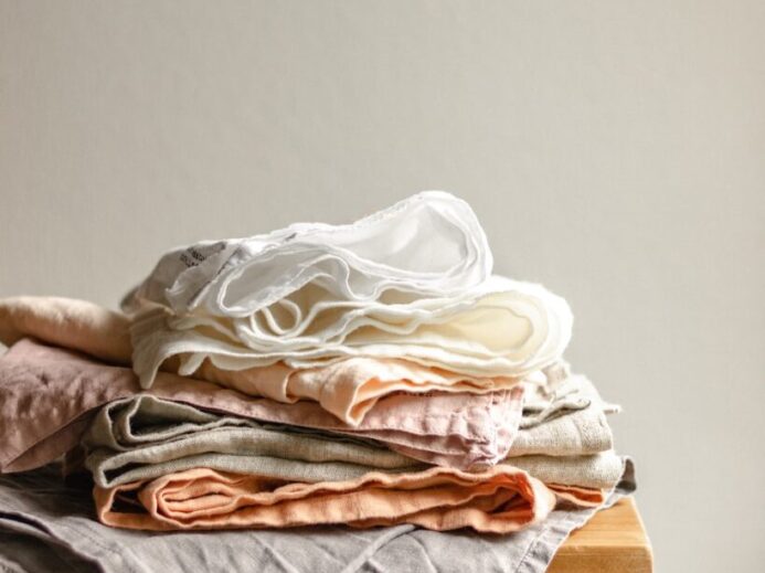white textile on brown wooden table