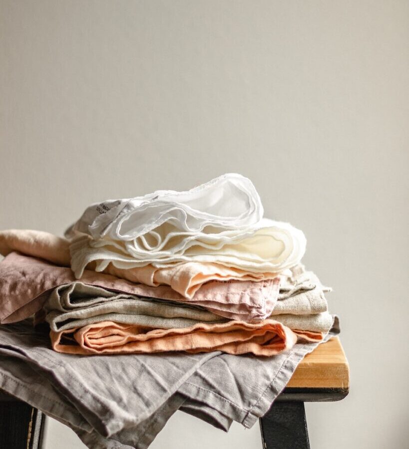 white textile on brown wooden table