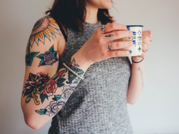 woman holding white ceramic mug
