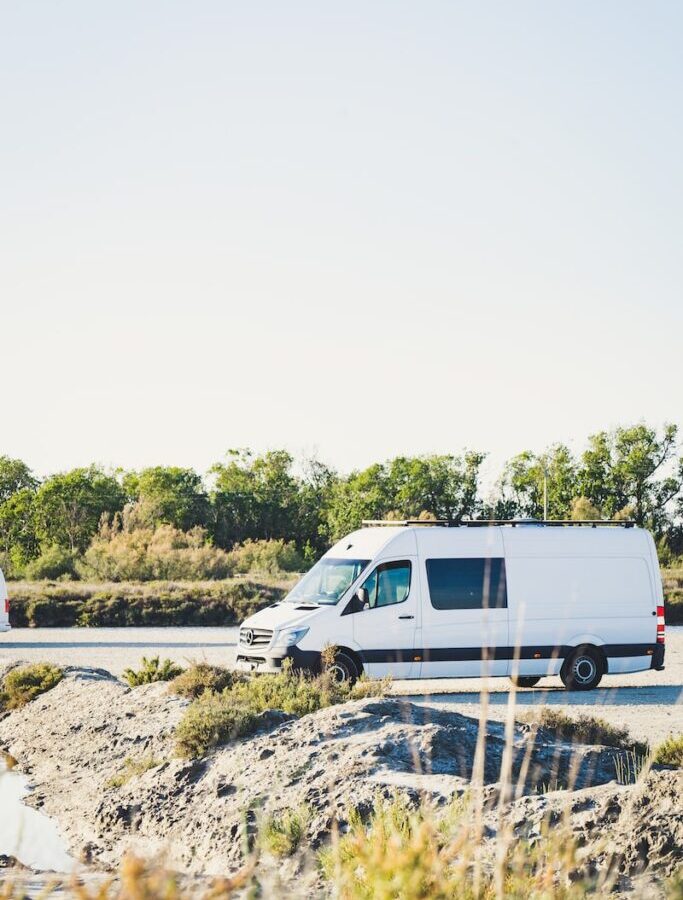 white van on gray concrete road during daytime