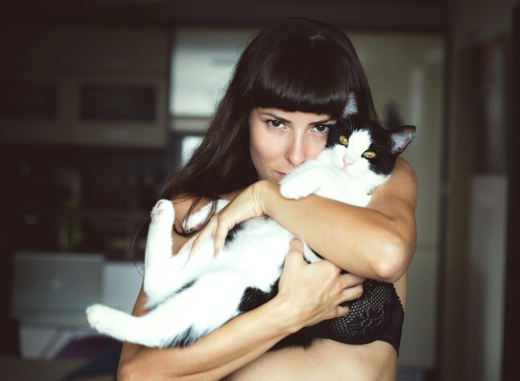 woman carrying cat