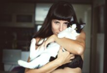 woman carrying cat
