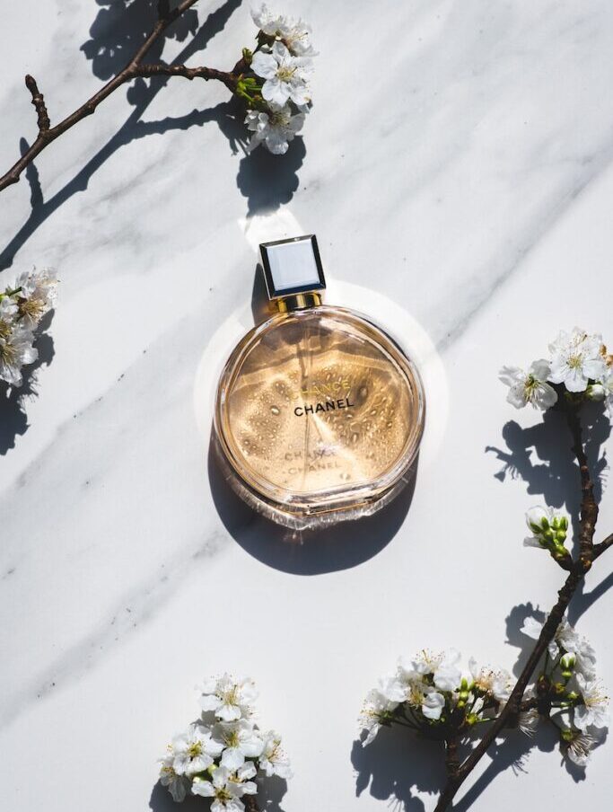 a bottle of perfume sitting on top of a white table
