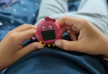 Chlapec drží v rulou růžové Tamagotchi